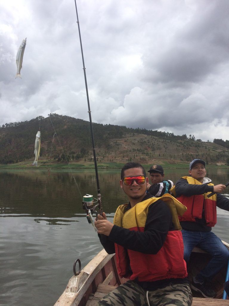 Traveller fishing from a boat on an Andean lake