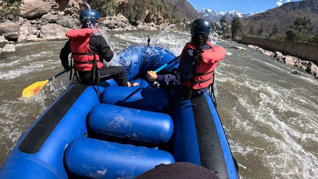 View from the raft of two paddlers moving through white water